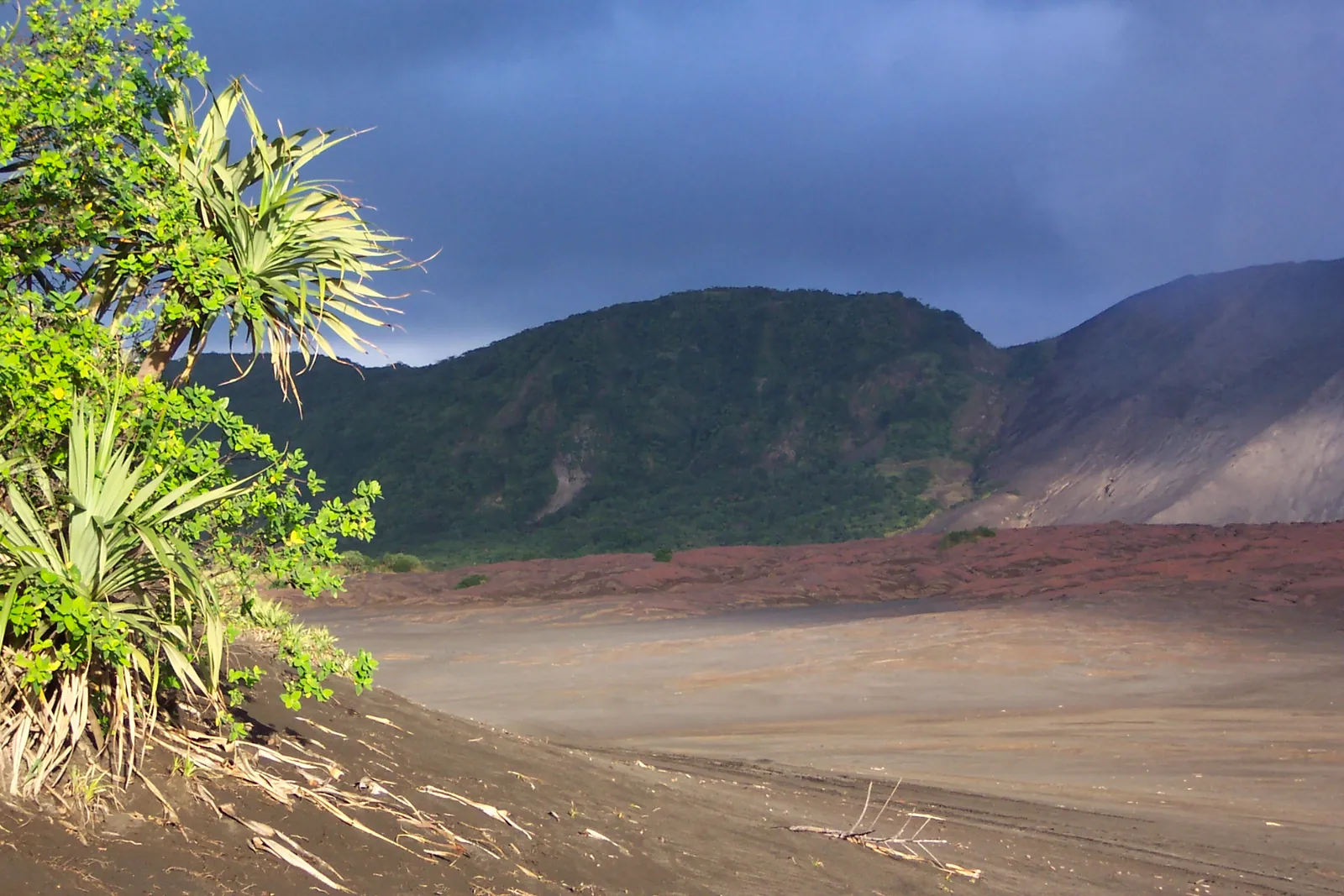 Green hills and the ash plain at the foot of Mount Yasur on Tanna